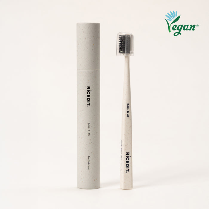 RICEDIT Edit 01 toothbrush with ivory handle, protective cap, and matching paper tube packaging