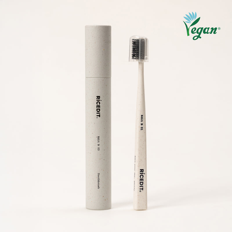 RICEDIT Edit 01 toothbrush with ivory handle, protective cap, and matching paper tube packaging