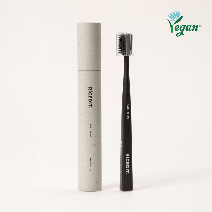 RICEDIT Edit 03 toothbrush with black handle, protective cap, and matching paper tube packaging